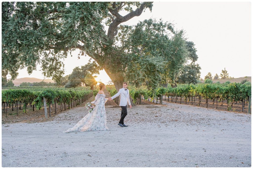 bride and groom walking in winery - sunstone winery during wedding