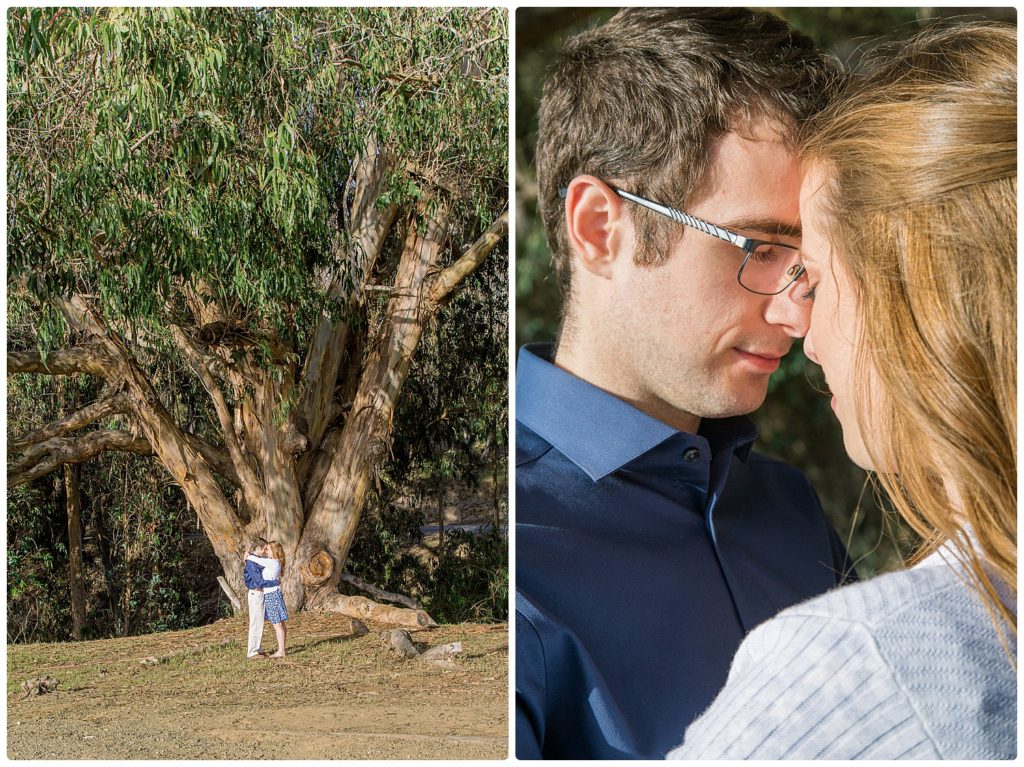 engaged couple in front of a large tree forehead to forehead