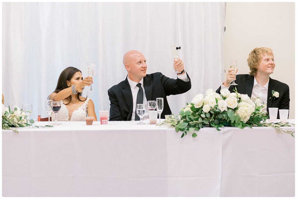 bride groom and best man toasting