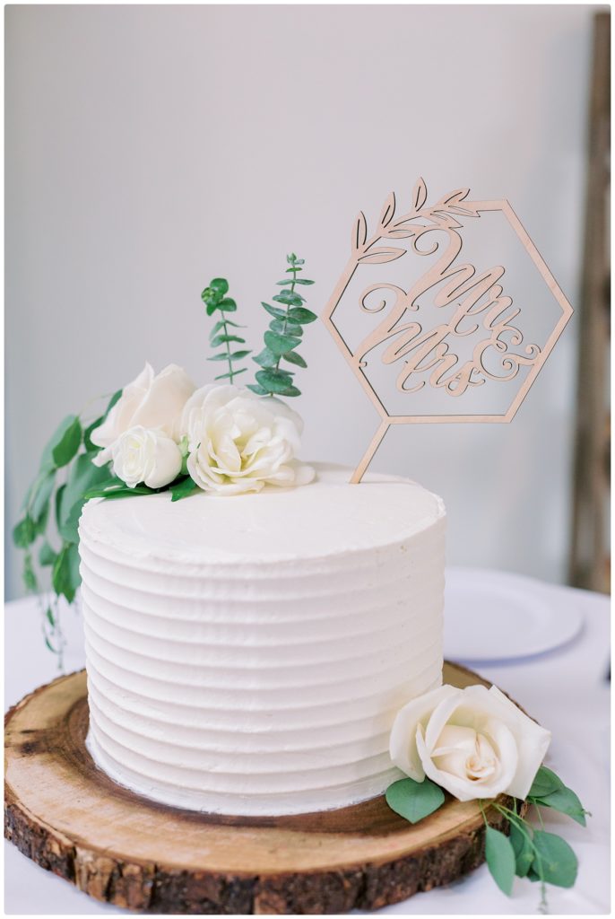 wedding cake on wooden charger