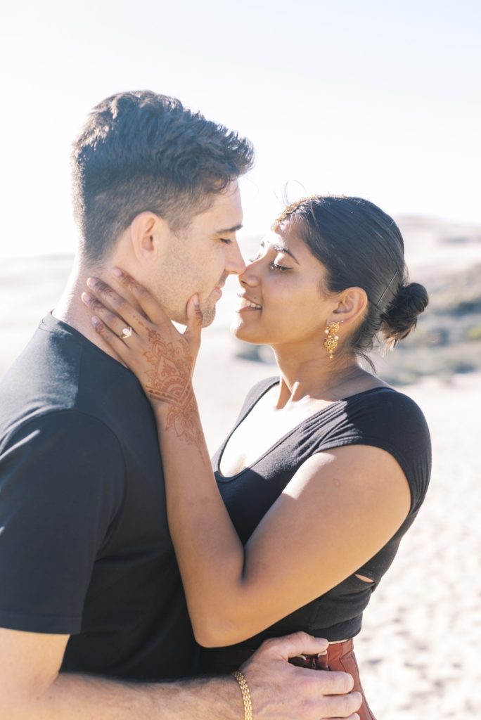 married couple embracing on beach 1